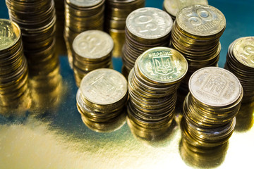 There are towers from gold coins. Currency. Business and finance. Profit. Ukrainian hryvnia.