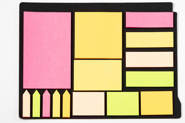 Blank note paper set of different colours forms and sizes. Sticky notes collection on black...