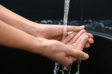 Woman washing hands in sink