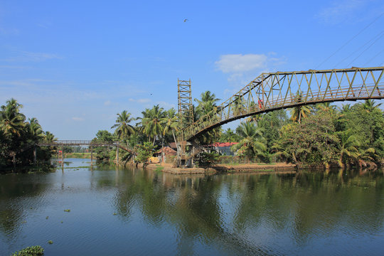 An old iron bridge across the beautiful backwaters in Kerala, India.