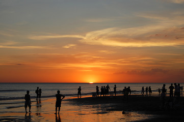 Fototapeta premium Silhouettes of people watching the sunse