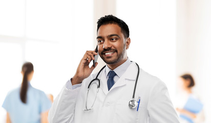 medicine, technology and healthcare concept - smiling indian male doctor in white coat with...