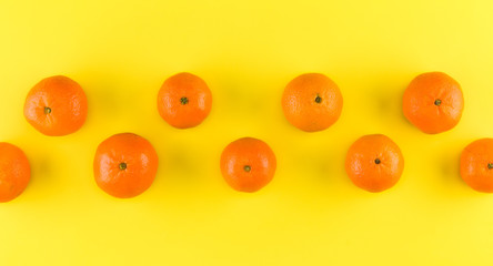 Fruit pattern of mandarin isolated on yellow background. Tangerine. Flat lay, top view.. Creative layout.