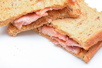 Freshly made bacon sandwich on a white plate