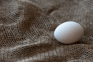 Chicken eggs on burlap.