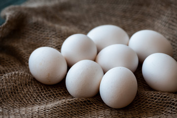 Chicken eggs on burlap.