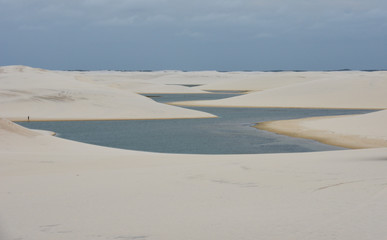 Fototapeta na wymiar Lagoon on the middle of the dunes at Lencois Maranhenese National Park, Brazil