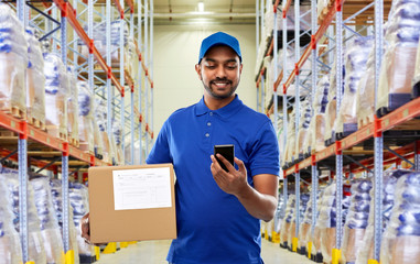mail service, technology and shipment concept - happy indian delivery man or warehouse worker with...