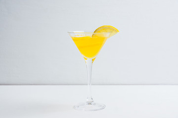 Fresh lemon cocktail in martini glass on the wooden background. Selective focus. Shallow depth of...