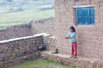 Fototapeta premium Native american little girl catching drops of the rain. Rural landscape.