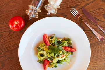 vegetable salad with tomatoes, shrimps and olives. diet food. lean food for believers