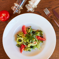 vegetable salad with tomatoes, shrimps and olives. diet food. lean food for believers