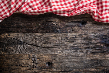 Red checkered kitchen tablecloth on rustic wooden table
