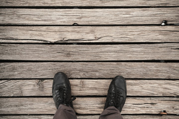 Male feet in black leather shoes
