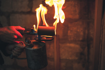 Old rusty blowtorch with flame