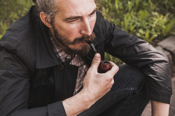 Brutal bearded man with pipe