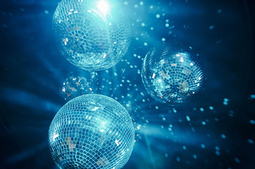Fototapeta na wymiar classic blue shining disco balls. disco atmosphere concept. color of the year 2020