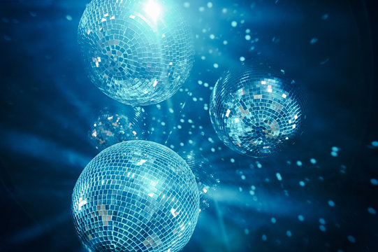 New year baubles. Shiny gold disco balls on neon background. Pop disco  style attributes, retro Stock Photo by jchizhe