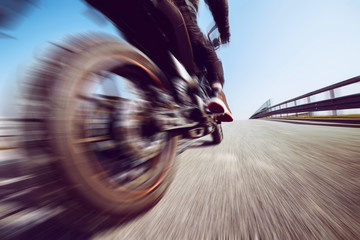 biker in action riding on the road - spring and summer outdoors leisure season and freedom concept-...