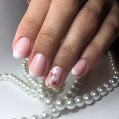 Flesh-colored manicure on nails. Female manicure
