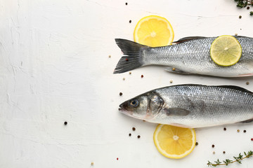 Tasty fresh seabass fish with spices on white background