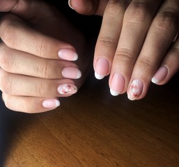 Flesh-colored manicure on nails. Female manicure