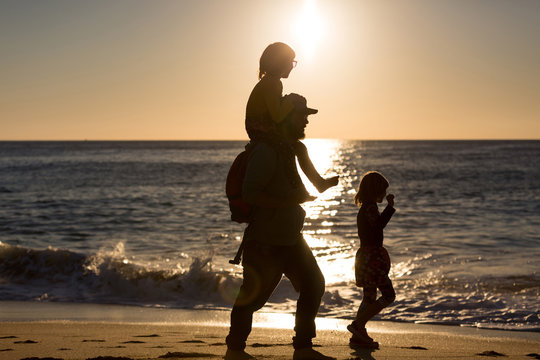 Father and children on the beach during sunset, Playa Zahora, Andaluc&iacute;a, Spain