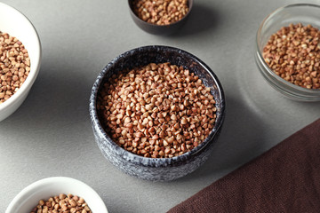 Bowls with raw buckwheat on table