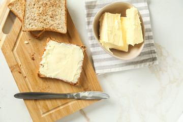 Composition with tasty toasts and butter on table