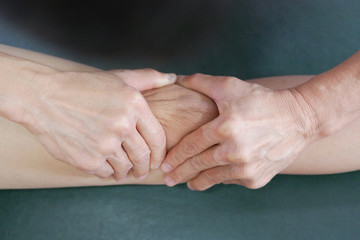 Fototapeta premium Physical therapist hands treat the knee to the patient