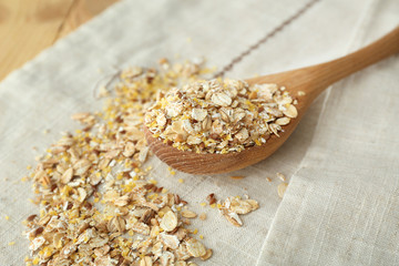 Spoon and scattered oatmeal on table