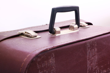 old and battered suitcase on white background