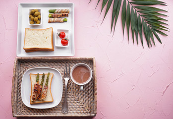 Composition with tasty bacon wrapped asparagus on color background