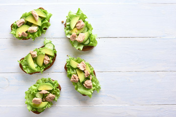 Tuna sandwiches with avocado and lettuce leaves
