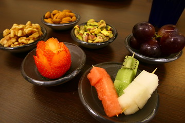 Bowls with a mix of different nuts and fruits.