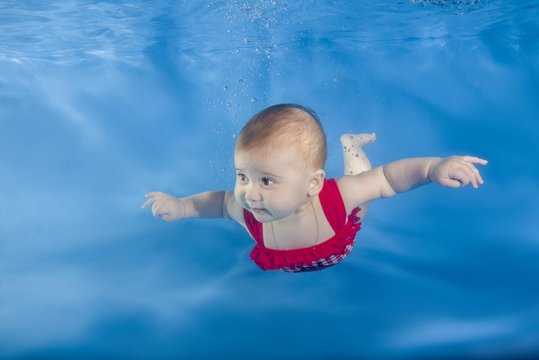 Little girl swims underwater, Ukraine, Europe