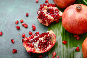Ripe pomegranates on color background