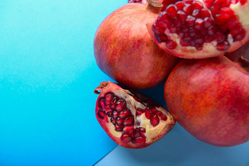 Ripe pomegranates on color background
