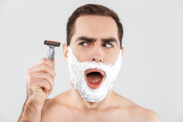 Portrait of a cheerful shirtless bearded man standing