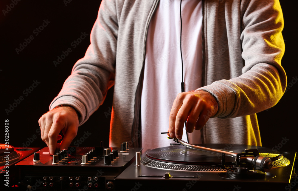 Wall mural male dj playing music in club