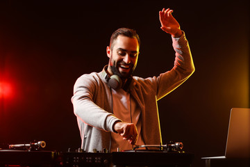 Male DJ playing music in club