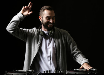 Male DJ playing music in club