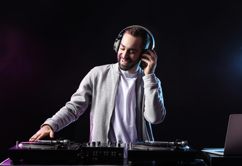 Male DJ playing music in club