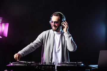 Male DJ playing music in club
