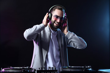 Male DJ playing music in club