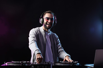 Male DJ playing music in club