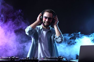 Male DJ playing music in club