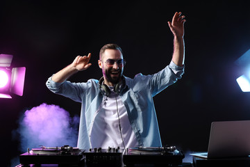 Male DJ playing music in club