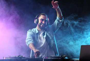 Male DJ playing music in club