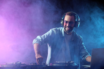 Male DJ playing music in club